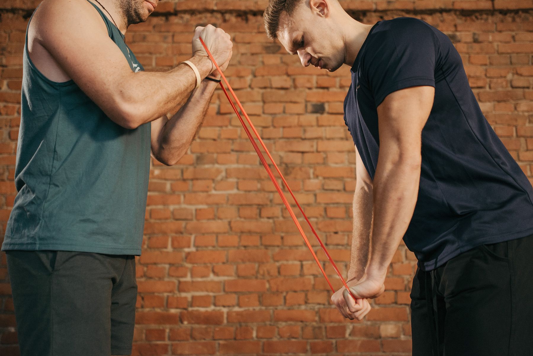 A coach guiding an athlete through resistance-band training