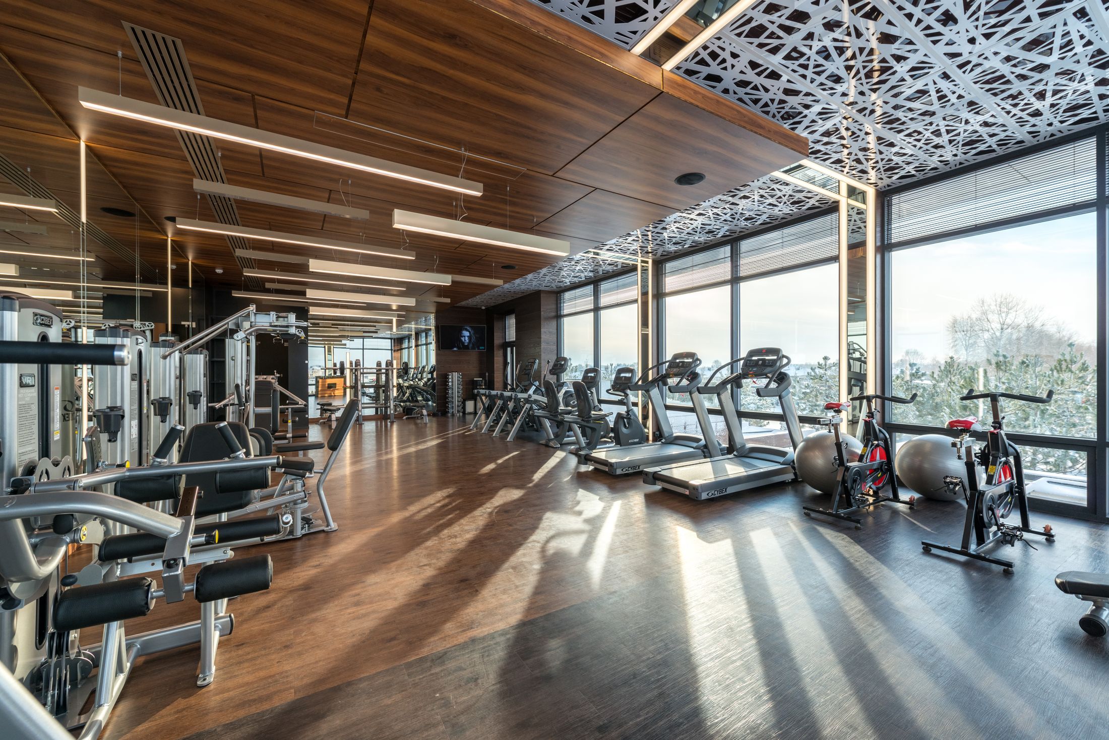 A contemporary fitness facility with natural light and modern equipment